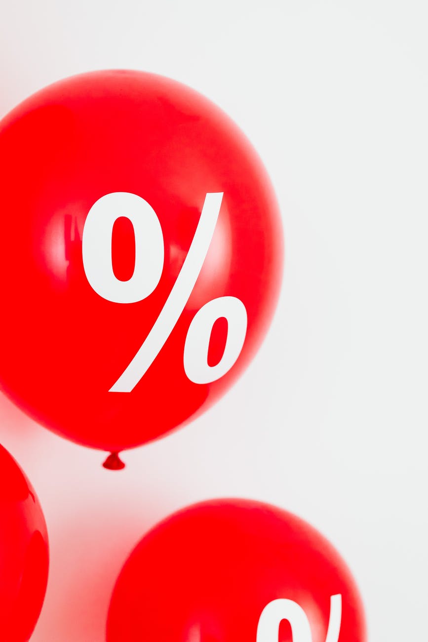 close up view of a red balloon with percentage symbol